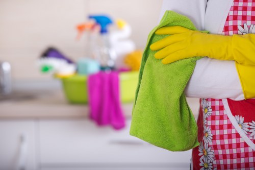 Office cleaning team sanitizing desks and shared workstations